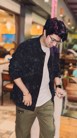 Shubham, walking through a cafe